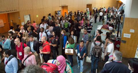 Sponsor exhibition hall with booths and attendees